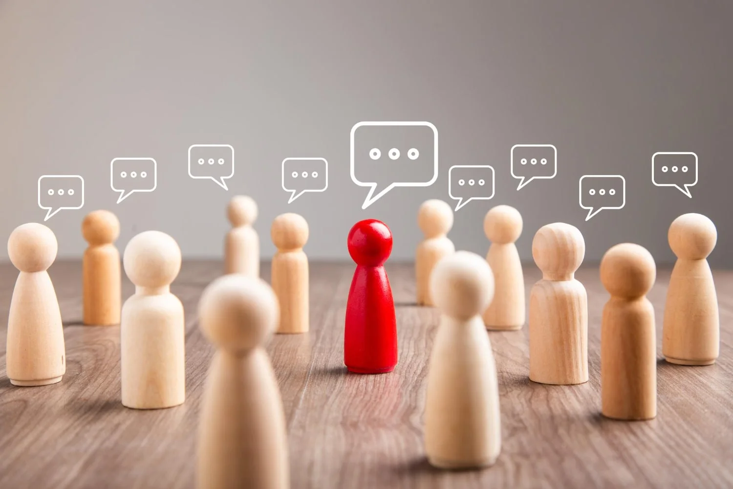 wooden figurine with speech bubble mingle discussion chatting concept