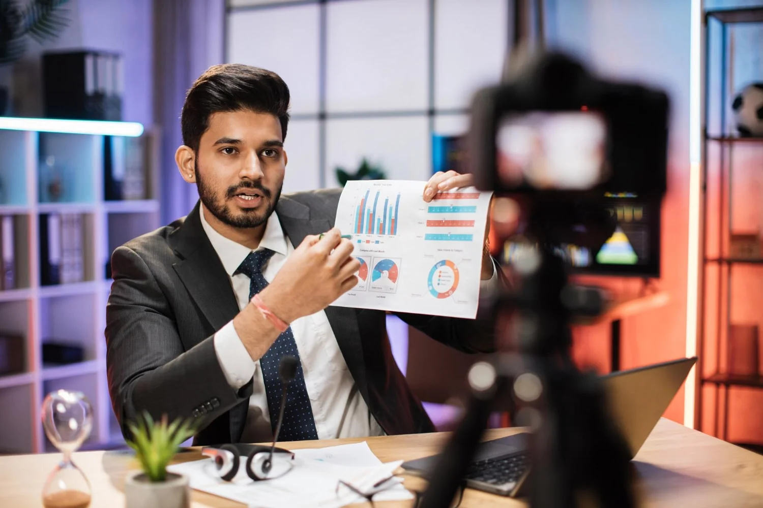 Image of a person using a laptop and looking at the camera, representing setting goals and KPIs for influencer marketing.