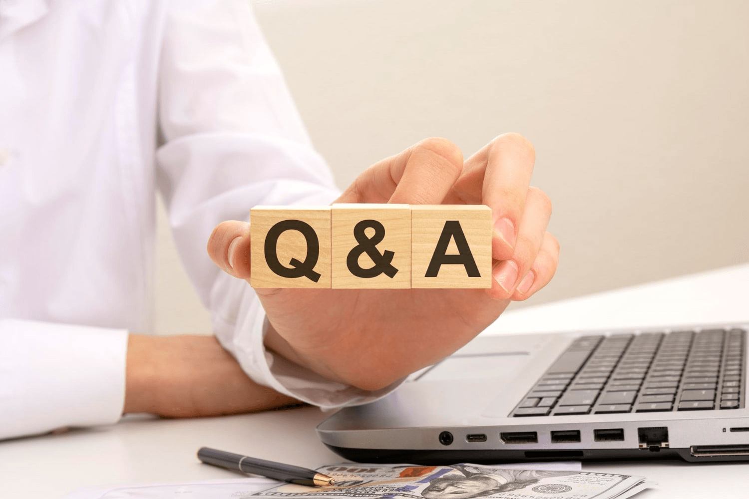 5 Effective Strategies to Discover Content Ideas for Social Media in 2024 3 Photo hand holds wooden cubes with inscription q and a short for question and answer white background help and tips concept